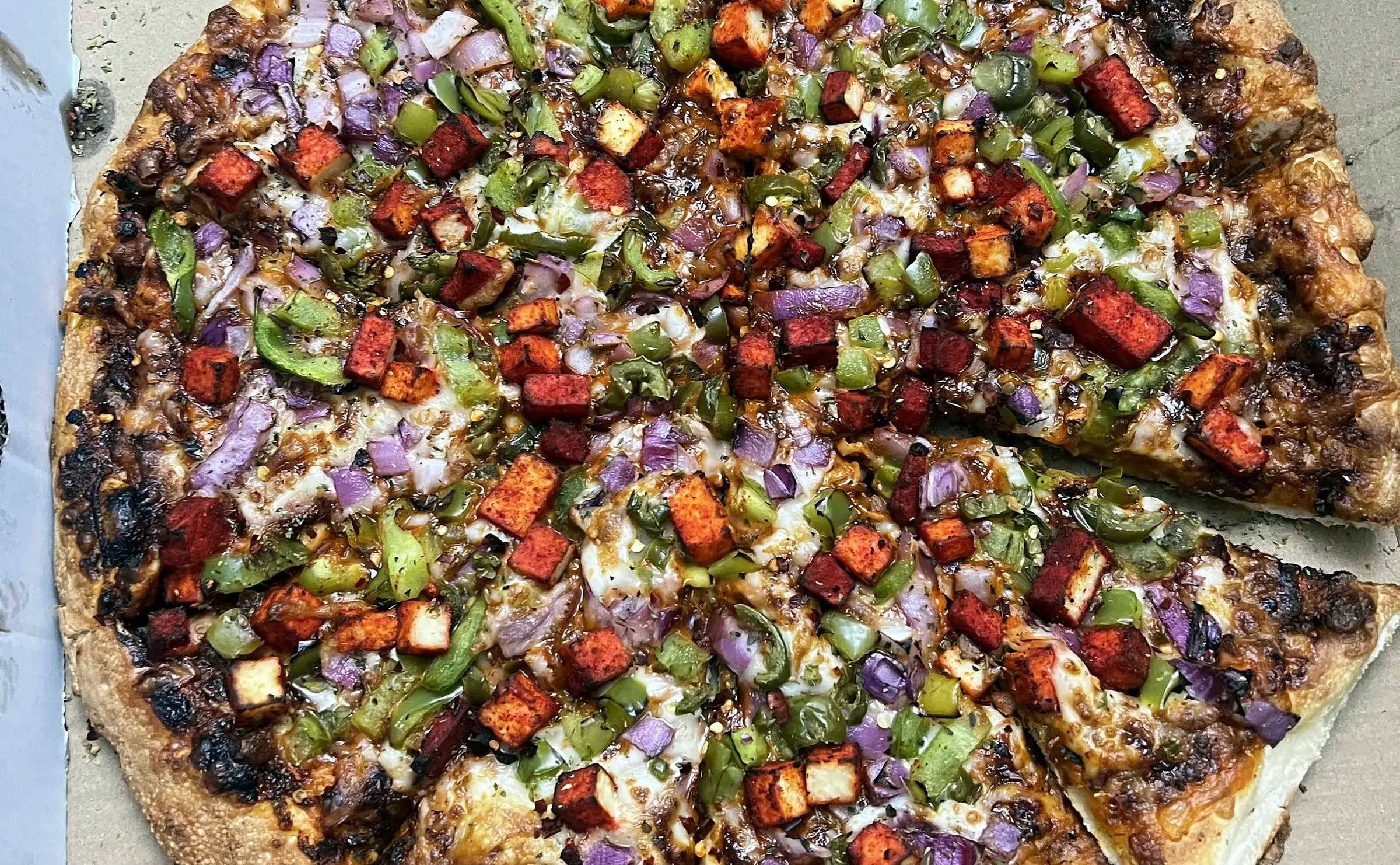 Loaded pizza in an open box